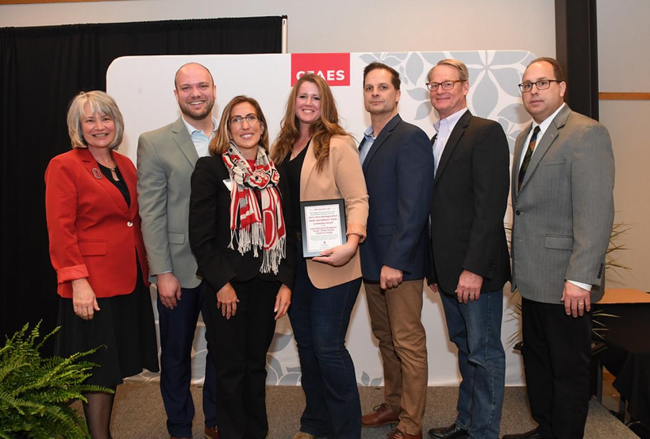 group of men and women receiving award