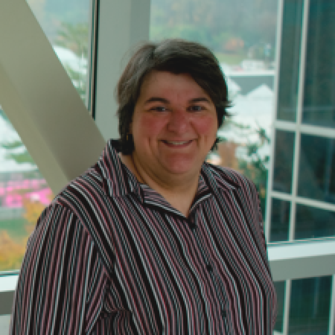 female with short dark hair and striped shirt