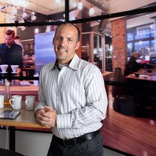 man leaning on counter