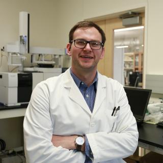 white male with glasses wearing lab coat