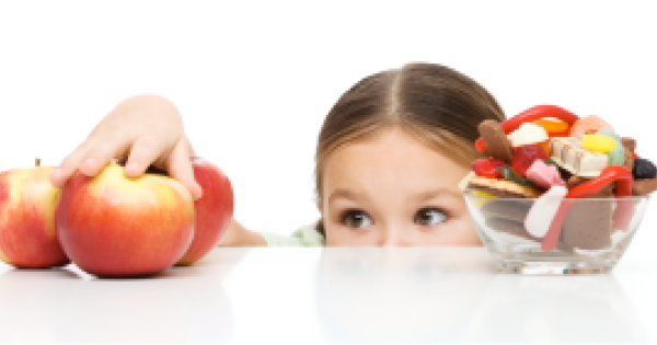 Child reaching for apples instead of candy