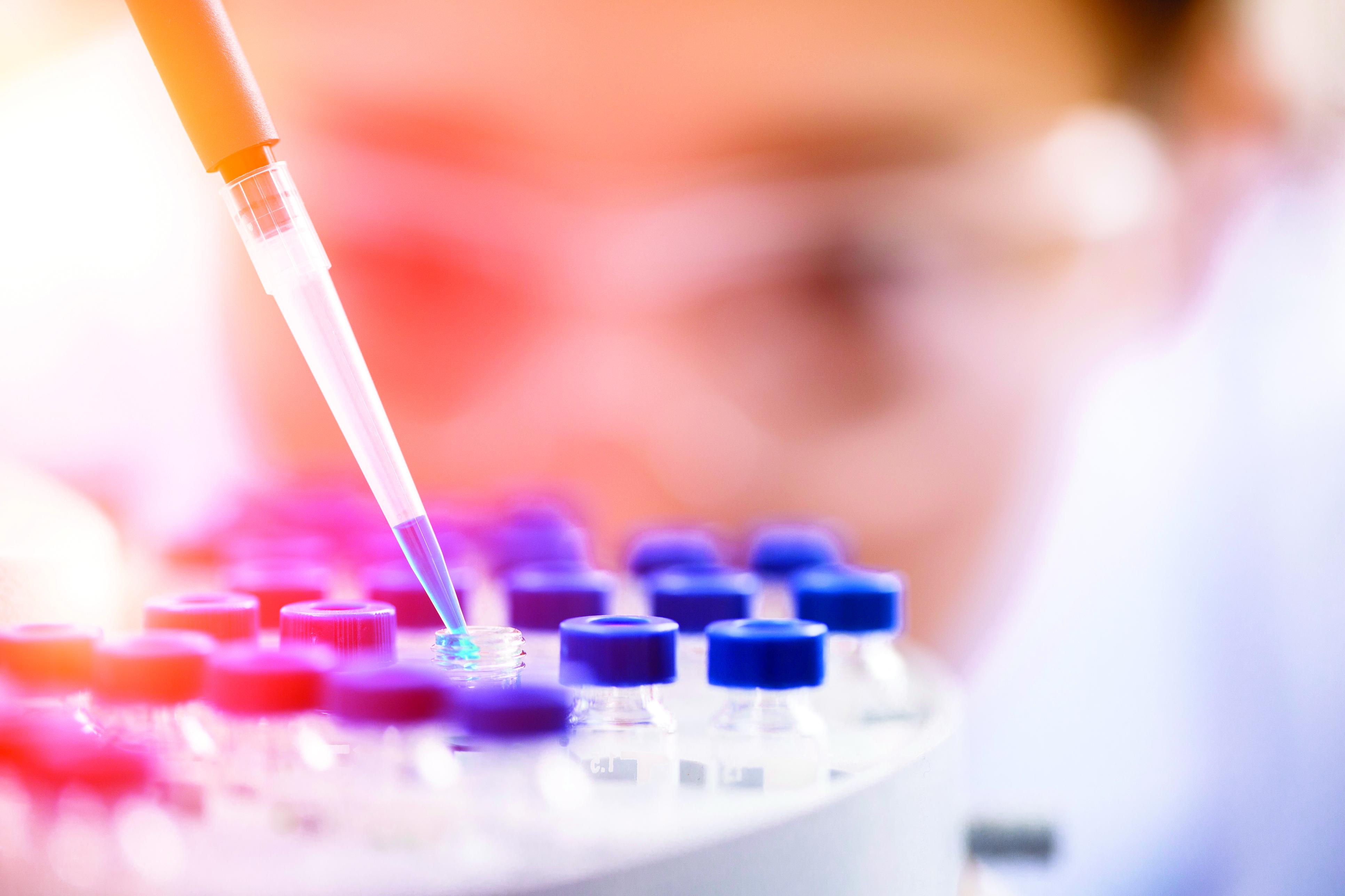 Image of a lab worker filling a vial