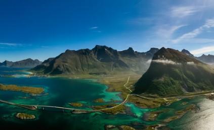 scene of water and mountains with blue sky