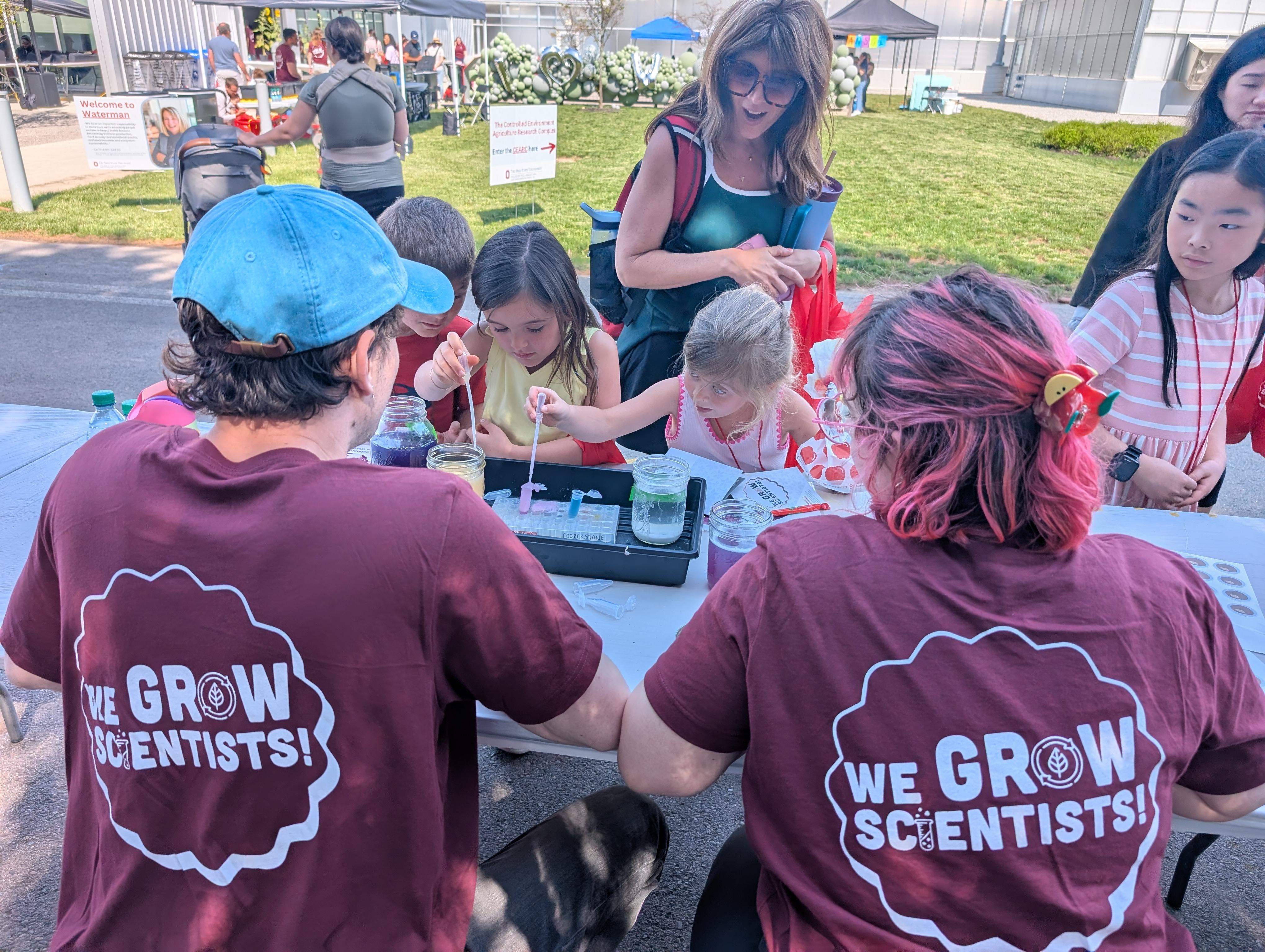 Lab students sitting with volunteer tshirts on